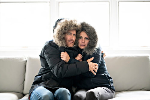 Couple,Have,Cold,On,The,Sofa,At,Home,With,Winter Freezing In House
