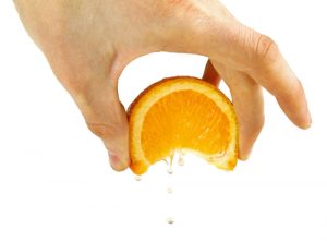 Hand Squeezing an Orange