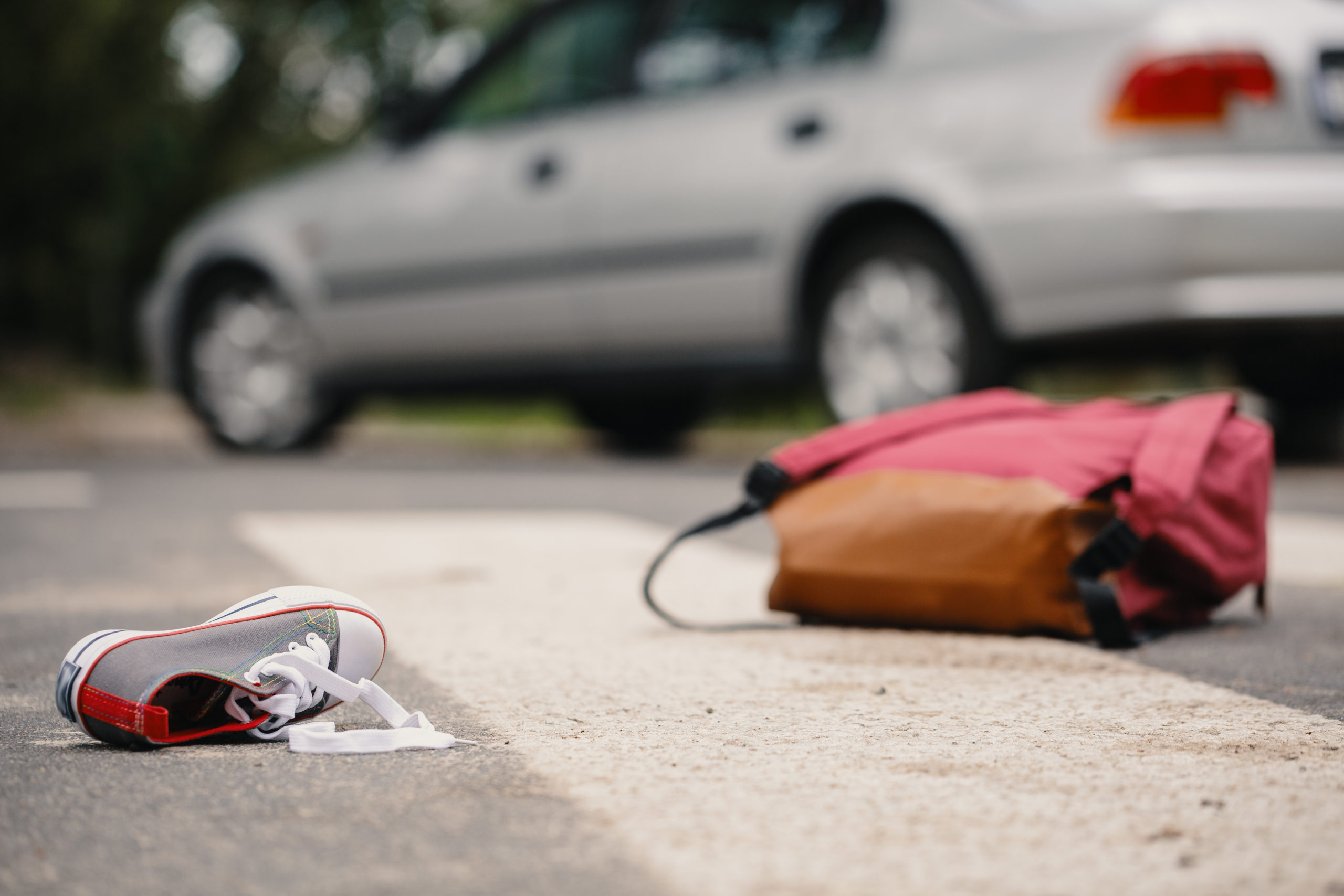 Crosswalk accident. Pedestrian with smartphone and headphones