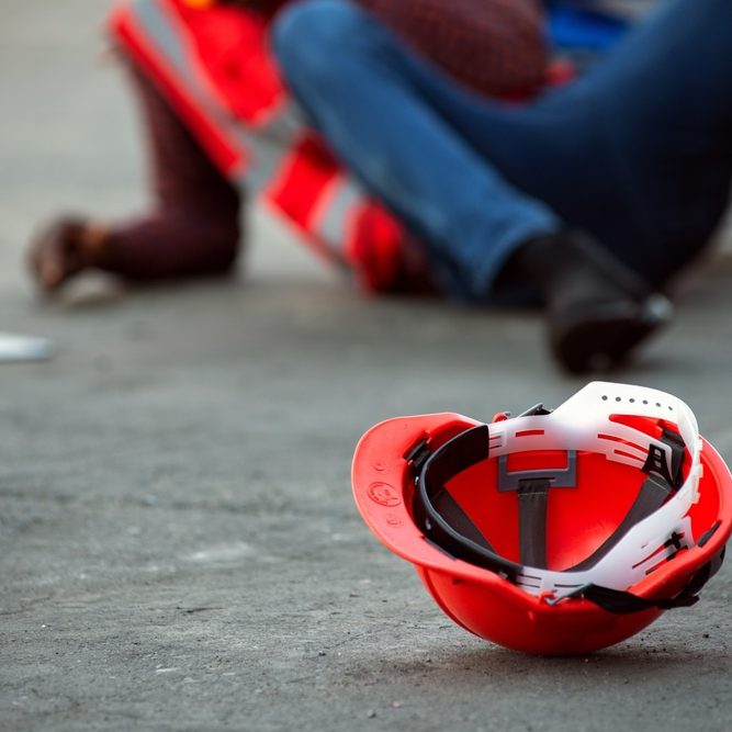 Red,Hard,Safety,Helmet,Hat,For,Engineer,On,Concrete,Ground