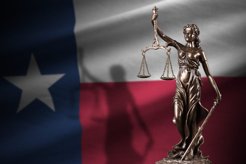 Texas,Us,State,Flag,With,Statue,Of,Lady,Justice,And